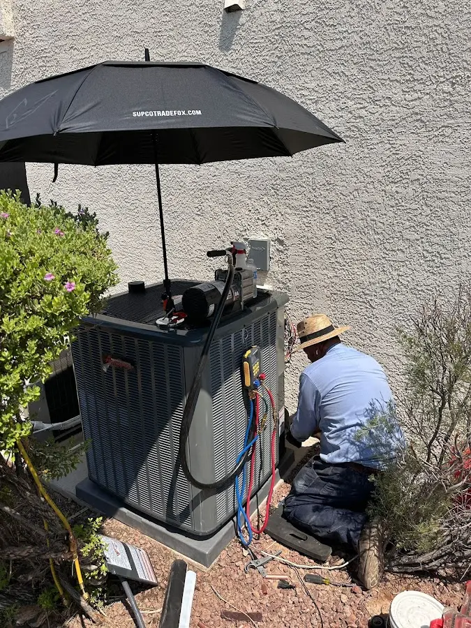 HVAC technician performing outdoor AC maintenance in Winter Gardens