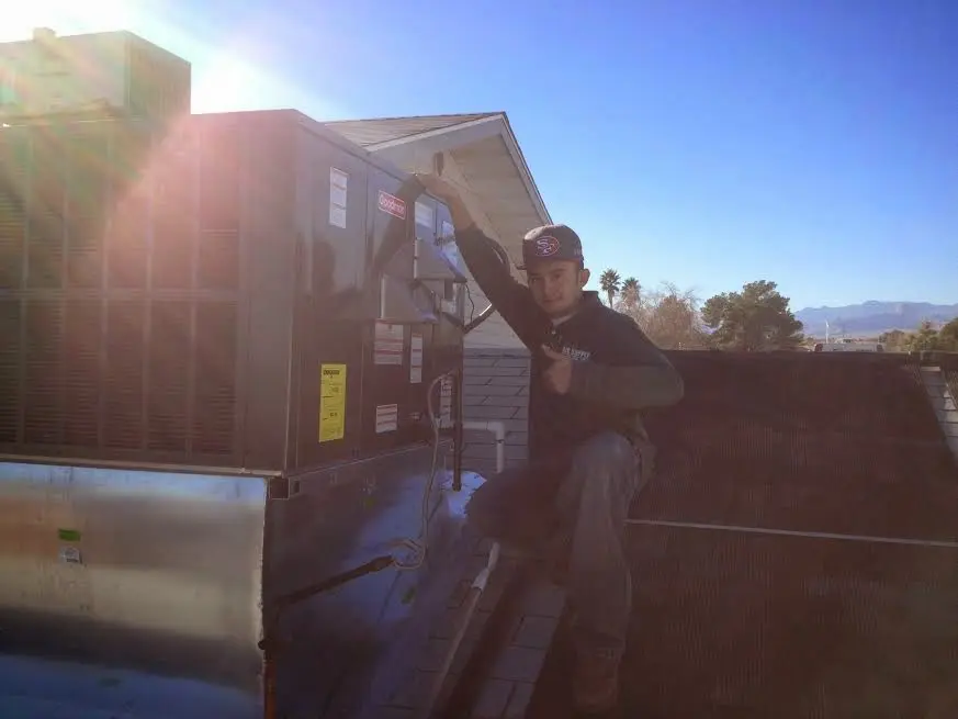 HVAC technician performing HVAC Inspection on a rooftop unit in Winter Gardens